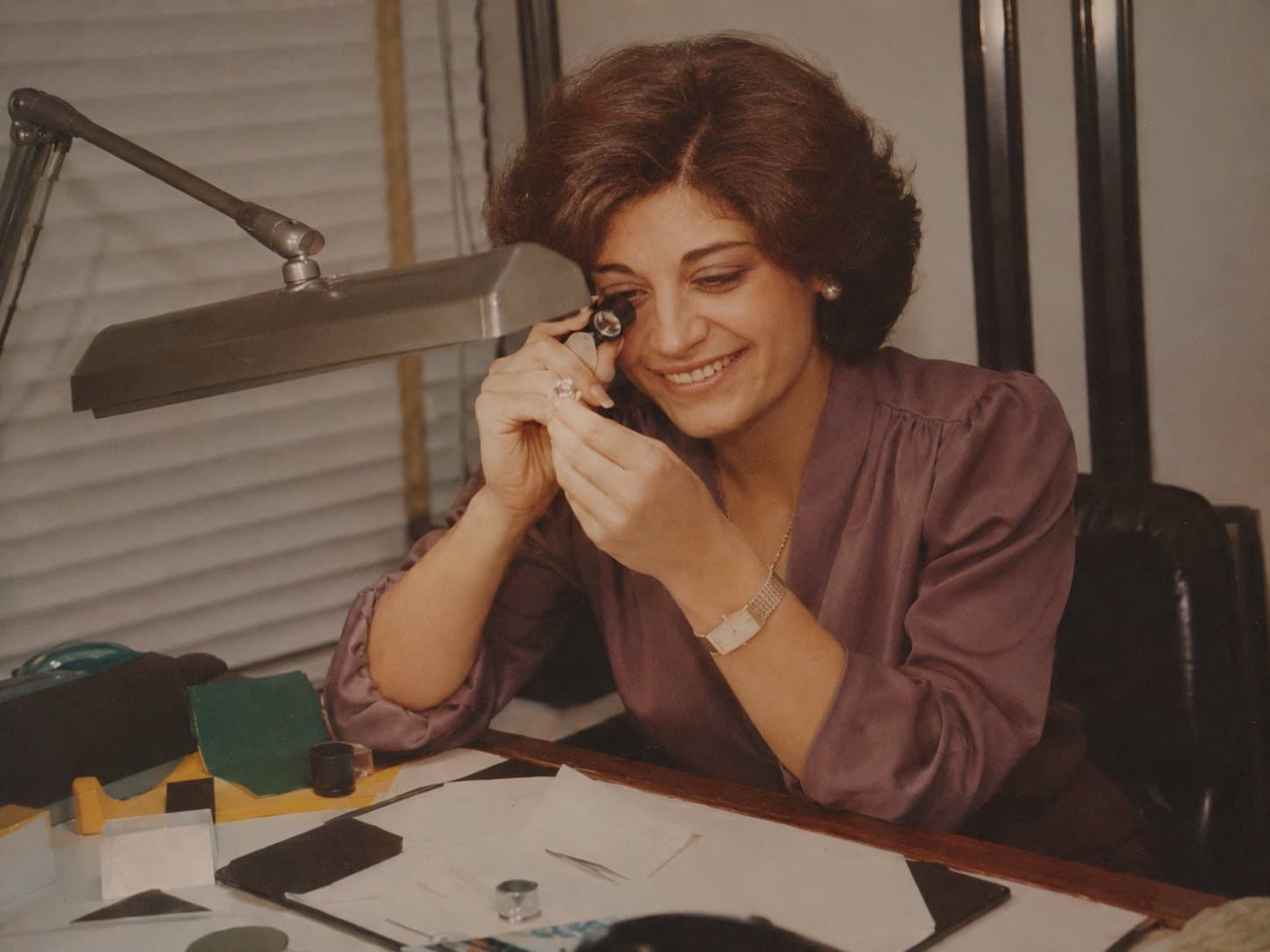 Audrey Pancis examining a gemstone at the bench