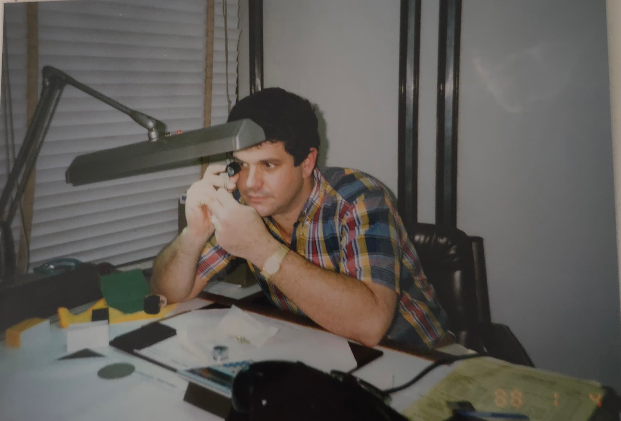 Jeff Pancis examining a stone through a jeweler's loupe